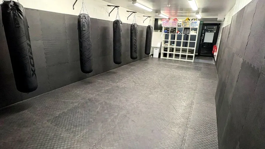 Main training room with heavy bags at Stewart Martial Arts & Fitness